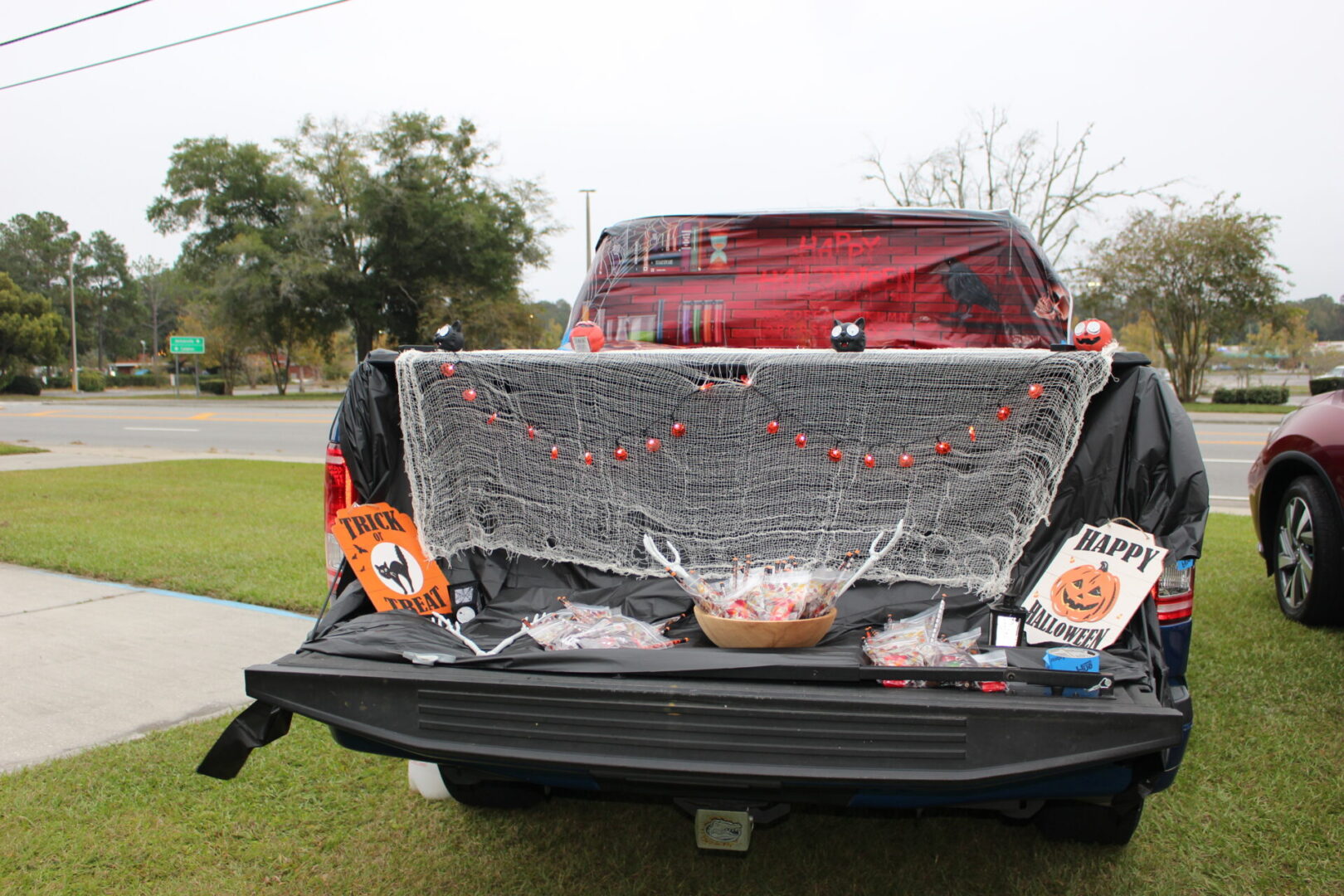 A trunk of a car with halloween decorations on it.